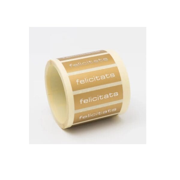 ET124-Rollo ETIQUETAS FELICITAS FONDO ORO MATE IMPRESIÓN PELÍCULA PLATA 50 x 15mm. 500ud.